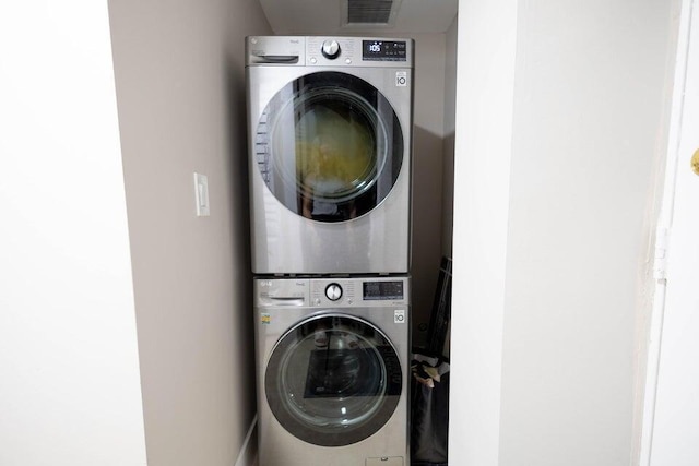 laundry room featuring stacked washer / dryer