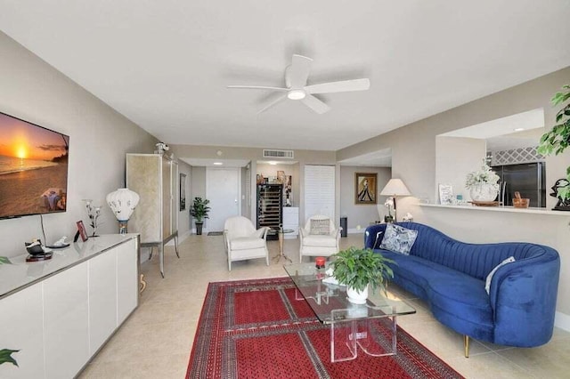 living room featuring ceiling fan and light tile patterned flooring