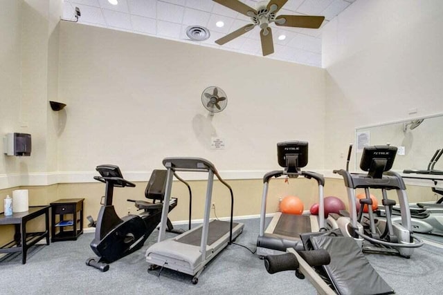 exercise room with carpet flooring and ceiling fan