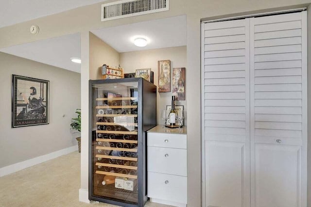 bar with light tile patterned floors and beverage cooler