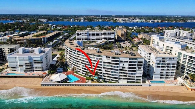 aerial view featuring a water view and a beach view