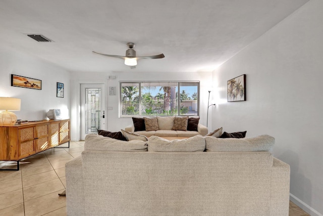 tiled living room featuring ceiling fan