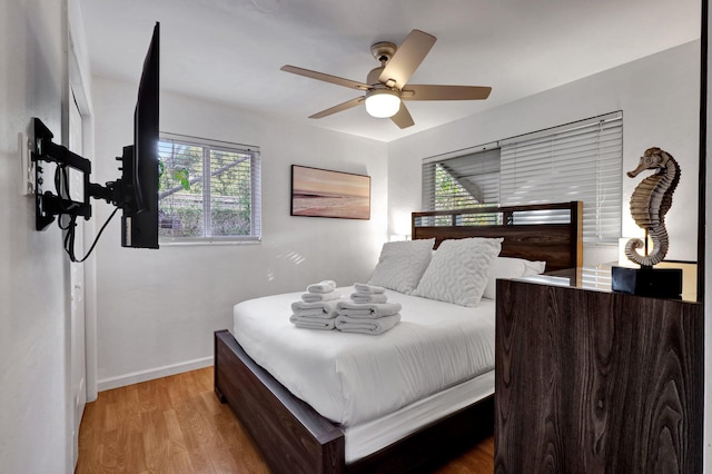 bedroom with hardwood / wood-style flooring and ceiling fan