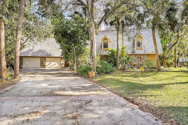 view of front of property with a front lawn and a garage