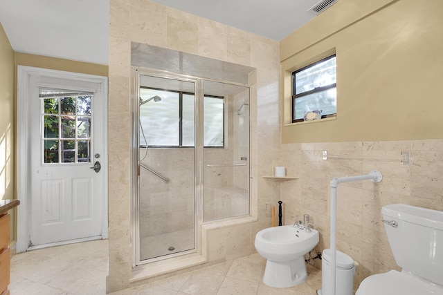 bathroom featuring a shower with door, a bidet, tile walls, tile patterned flooring, and toilet