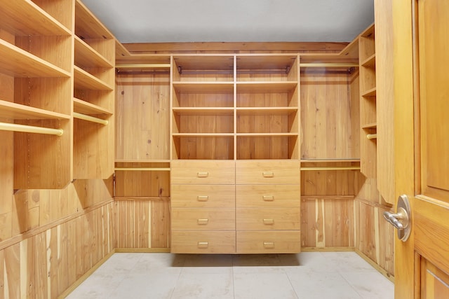 spacious closet with light tile patterned floors