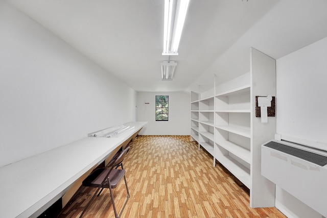 office space featuring light wood-type flooring and radiator heating unit