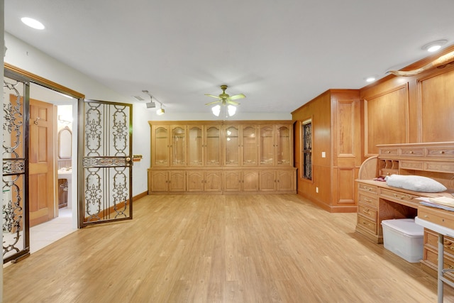 living room with ceiling fan and light hardwood / wood-style flooring