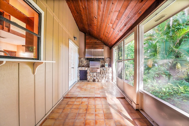 unfurnished sunroom with wood ceiling and vaulted ceiling