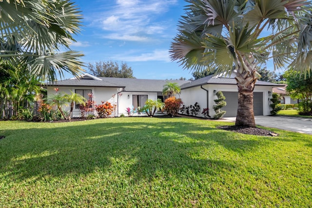 view of front of property with a front yard and a garage