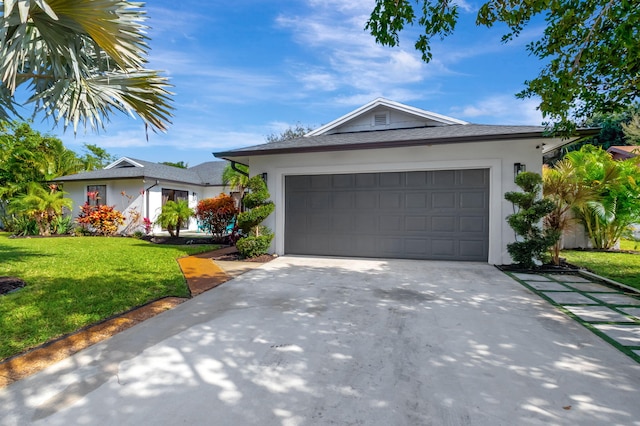 view of front of home featuring a front yard and a garage