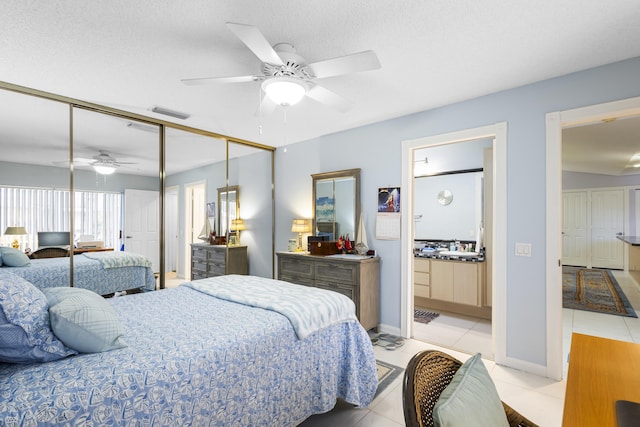 tiled bedroom featuring a textured ceiling, a closet, and ceiling fan