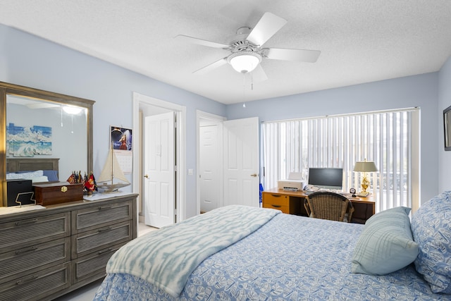 bedroom with ceiling fan and a textured ceiling