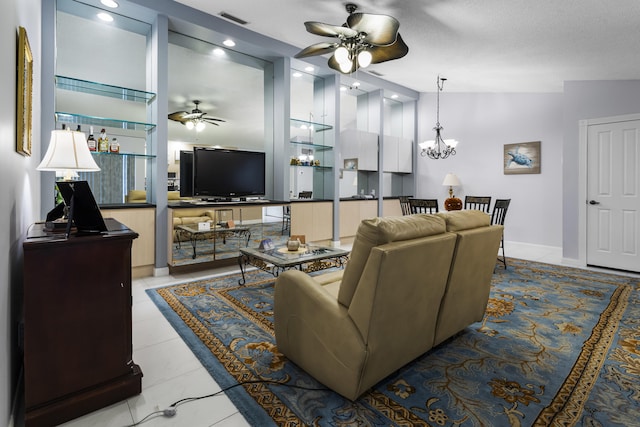 living room featuring ceiling fan with notable chandelier, light tile patterned floors, a textured ceiling, and vaulted ceiling