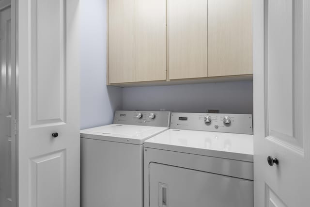 laundry area with cabinets and washing machine and dryer