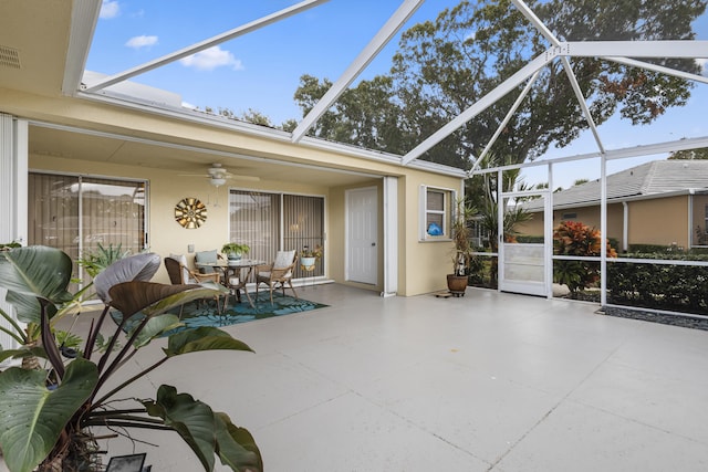 sunroom featuring ceiling fan and a pool