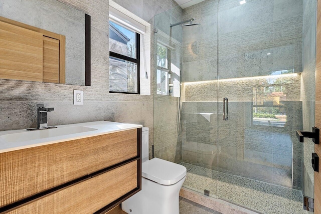 bathroom featuring backsplash, an enclosed shower, toilet, vanity, and tile walls