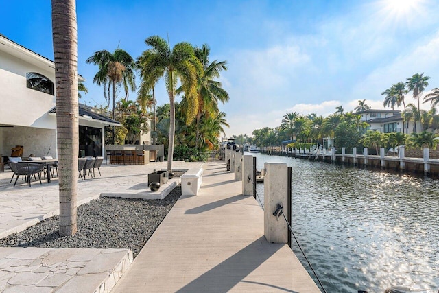 view of dock featuring a bar and a water view