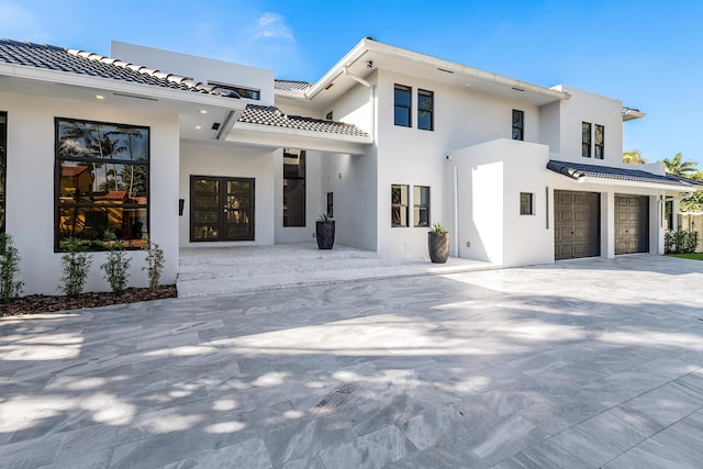 back of house featuring french doors and a garage