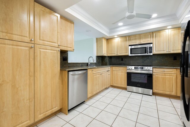 laundry area with light tile patterned floors and stacked washing maching and dryer