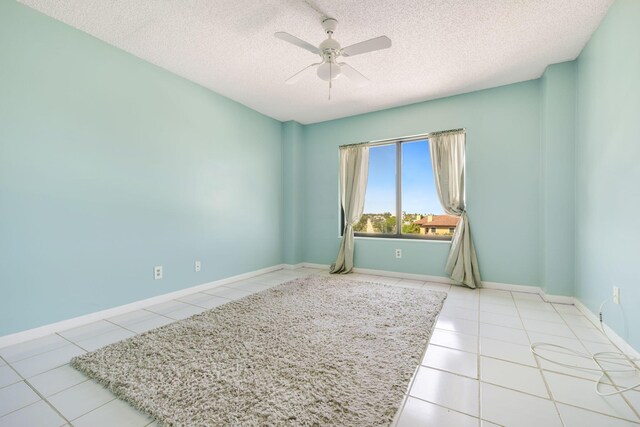 bedroom with a closet, light tile patterned flooring, and a textured ceiling