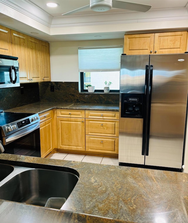 kitchen featuring backsplash, dark stone counters, sink, ornamental molding, and appliances with stainless steel finishes