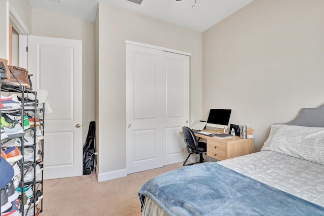 bedroom featuring light colored carpet and a closet