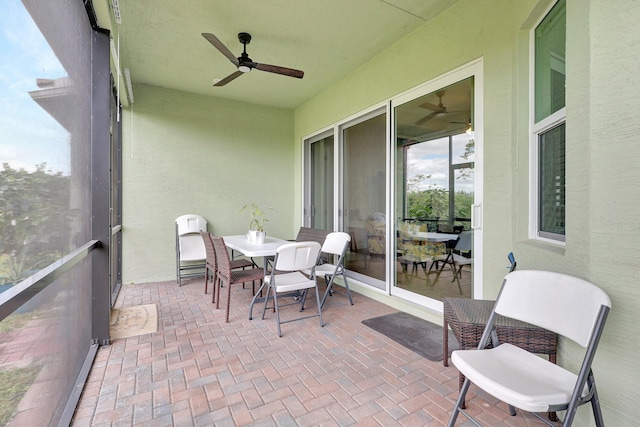 sunroom featuring ceiling fan