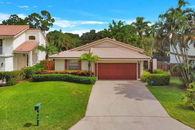 mediterranean / spanish home with a garage and a front lawn