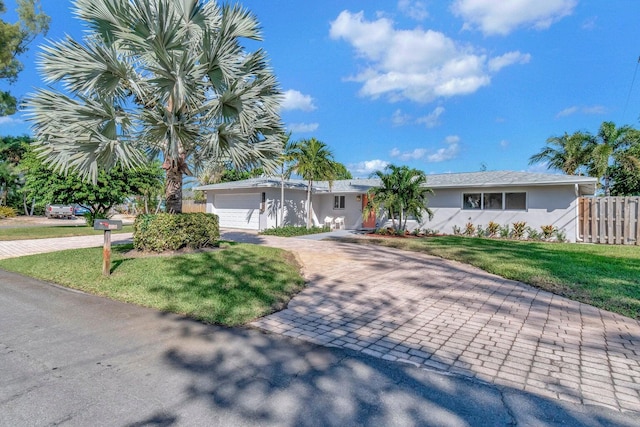 view of front of house with a front yard and a garage