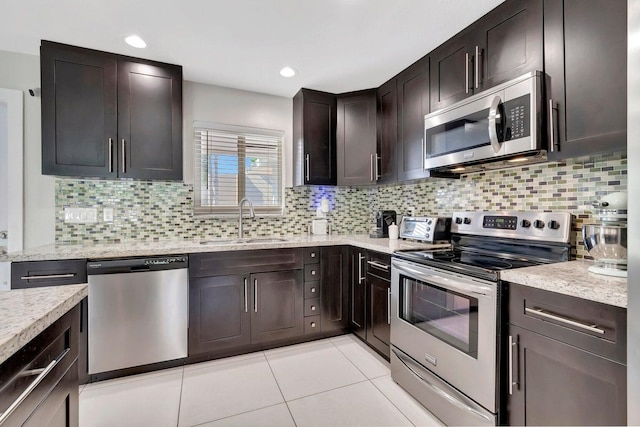 kitchen with tasteful backsplash, sink, and stainless steel appliances