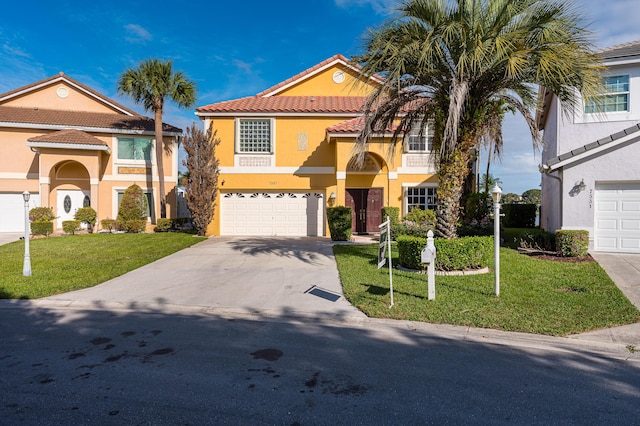 mediterranean / spanish home with a garage and a front lawn