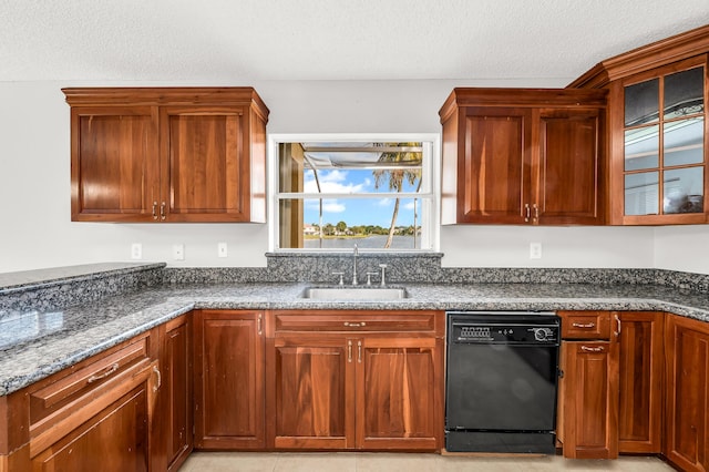 kitchen featuring dishwasher, dark stone counters, a textured ceiling, and sink