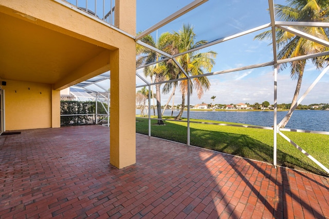 view of patio / terrace with a lanai and a water view