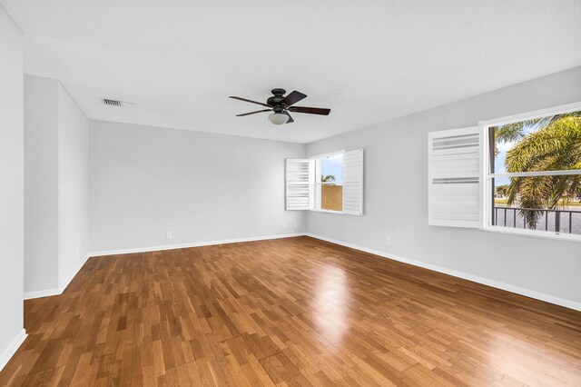 unfurnished room with ceiling fan and wood-type flooring