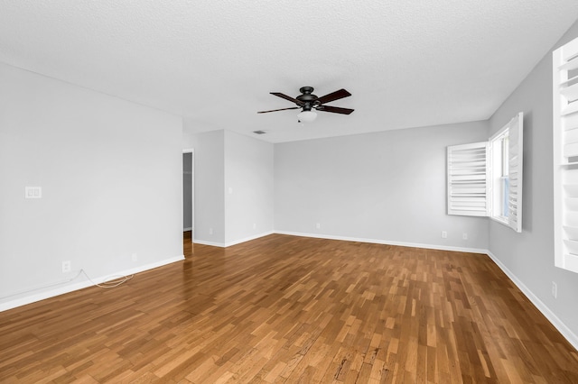 empty room featuring ceiling fan, a textured ceiling, and hardwood / wood-style flooring