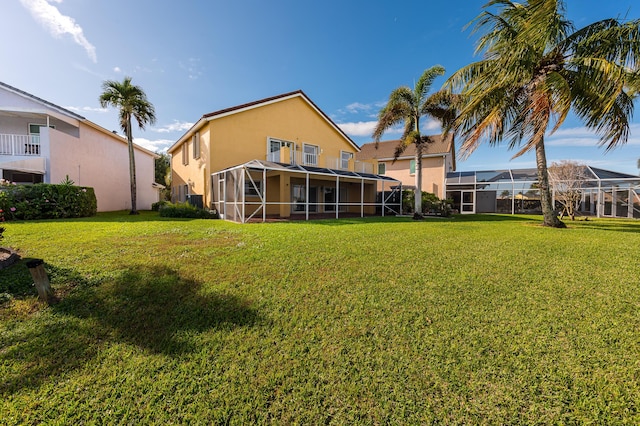 rear view of property featuring a lawn