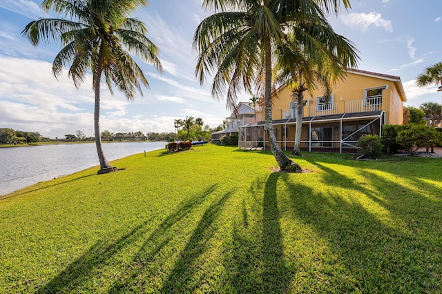 view of yard featuring a balcony and a water view