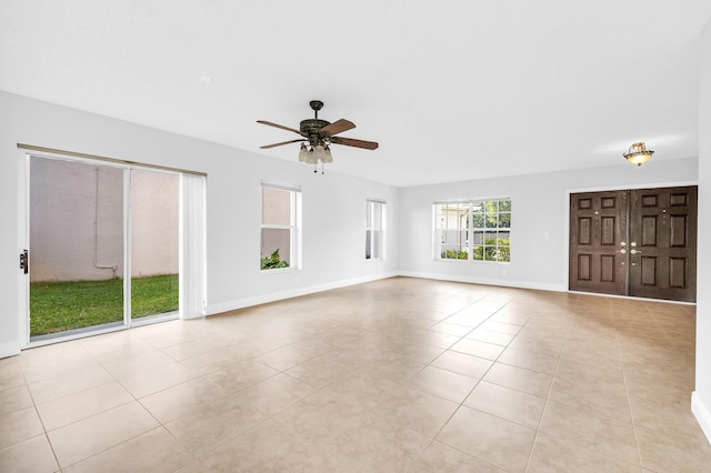 unfurnished living room with ceiling fan and light tile patterned flooring