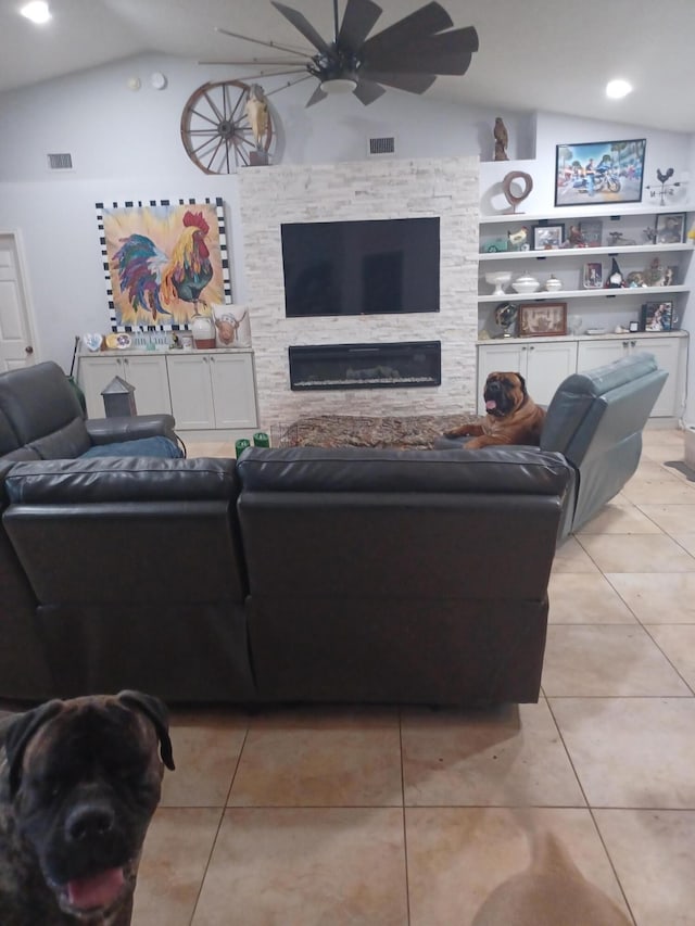 tiled living room featuring a fireplace, vaulted ceiling, and built in features