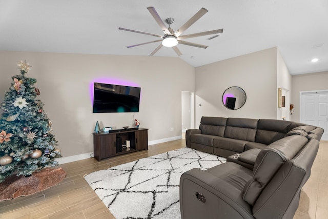 living room featuring ceiling fan and vaulted ceiling