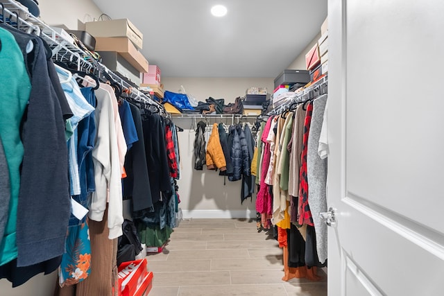 spacious closet with light hardwood / wood-style flooring