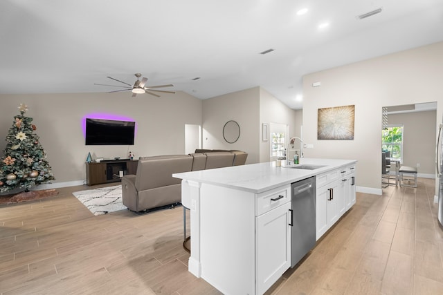 kitchen with white cabinetry, dishwasher, ceiling fan, vaulted ceiling, and a kitchen island with sink