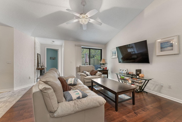 living room with ceiling fan, vaulted ceiling, dark wood-type flooring, and a textured ceiling