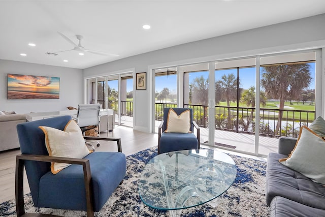 living room featuring ceiling fan and light wood-type flooring