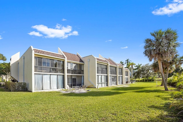 rear view of property featuring a yard