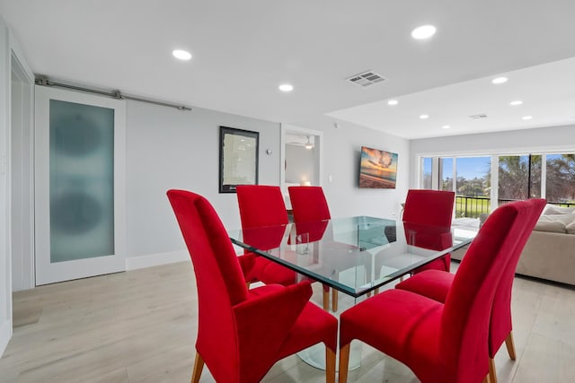 dining space with light wood-type flooring