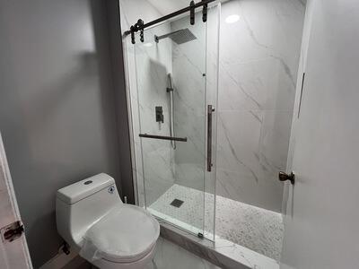 bathroom featuring toilet and walk in shower