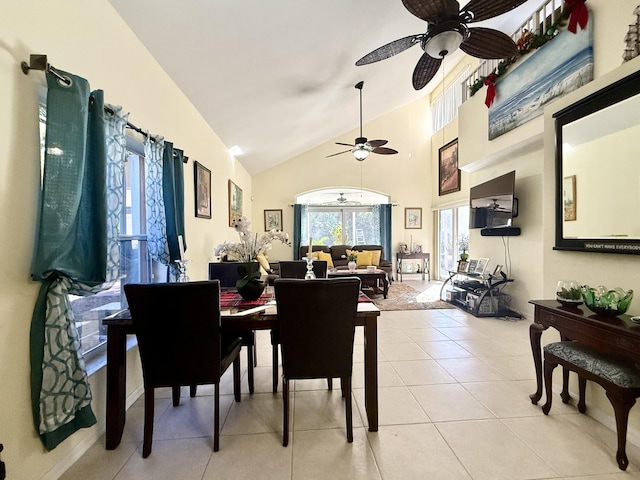 tiled dining room featuring ceiling fan and lofted ceiling