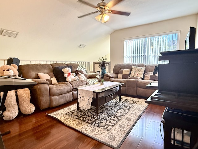 living room featuring ceiling fan, dark hardwood / wood-style flooring, and vaulted ceiling